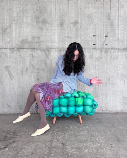 Woman sat on colour-changing Pangolin bench by Jacob Walls