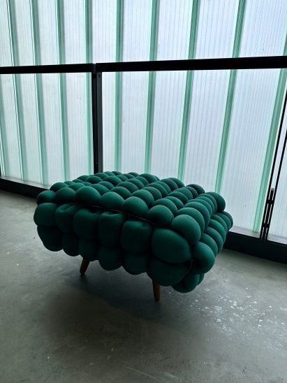 Bulbous green bench in a hallway