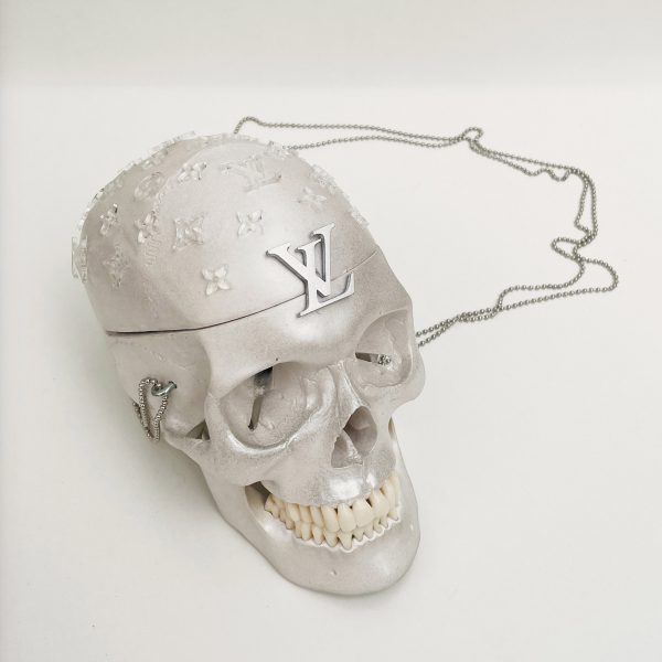a photograph of a skull painted in silver