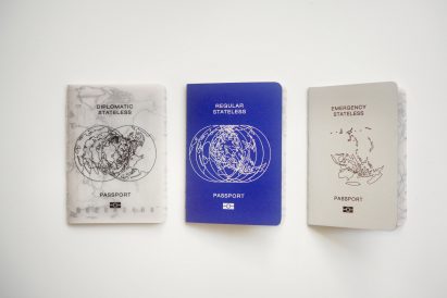 a photograph of three passport designs in tones of white and blue