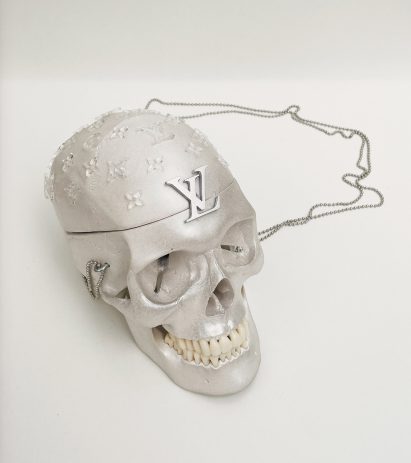 a photograph of a skull painted in silver