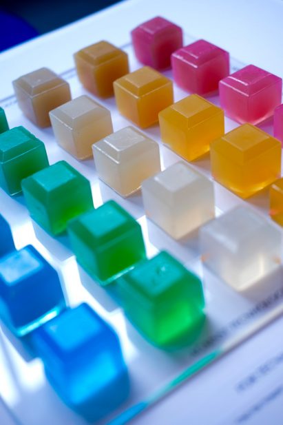 a photograph of jelly cubes in tones of blue, green, orange, clear and pink