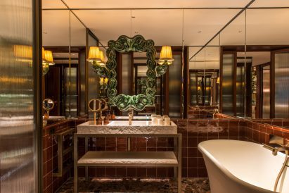 Glazed terracotta frame on mirrored bathroom wall