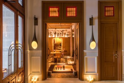 Hotel lobby with luggage trolley and hanging lights