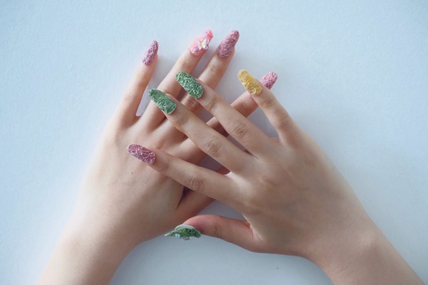 a photograph of a person's hands wearing press on nails