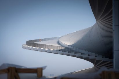 Man standing on spiral staircase