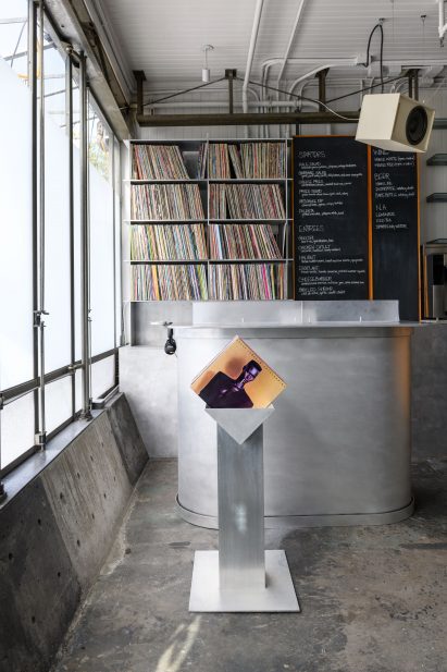 A custom brushed aluminium DJ in the front of a bistro