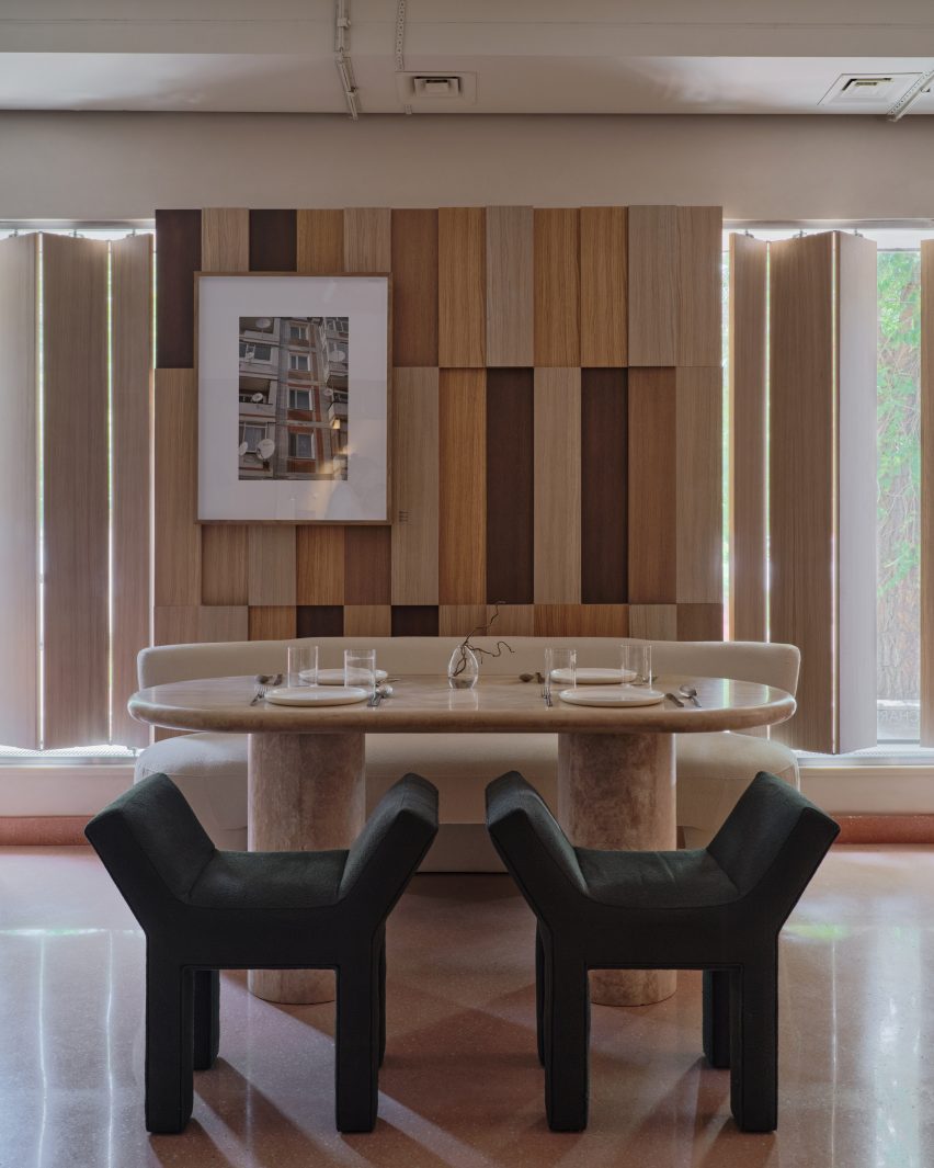 Marble table with green chairs in front