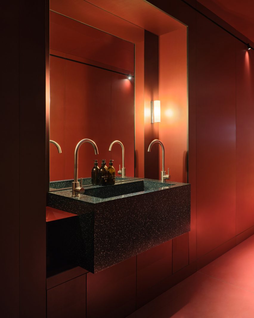 Bathroom with red panels lining the walls and floor