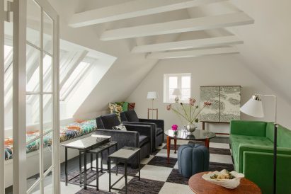 Green sofa on black and white floor