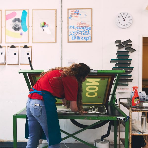 a photograph of a person screen printing