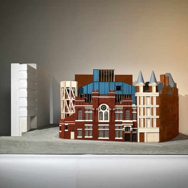 a photograph of an architectural model in tones of brown and blue