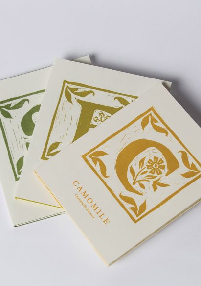 a photograph of three books in tones of white, yellow and green