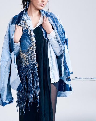 Model wearing a garment made up of different shades of blue fabric