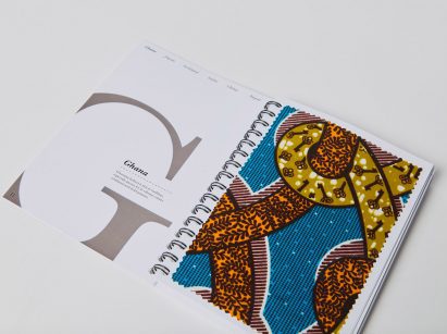 a photograph of an open book in tones of white, grey, blue, brown and yellow