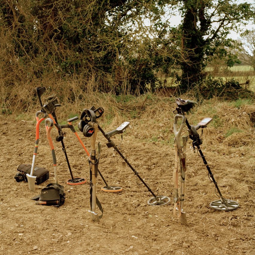 a photograph of three metal detectors in a field