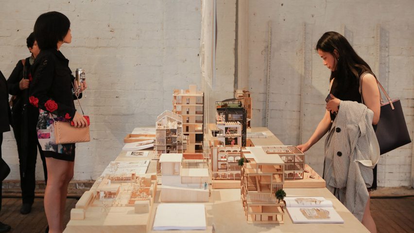 a photograph of people interacting with an exhibition