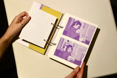 Photo of the book 4,4,4&2 open to an albu-like page with two monochrome photos of a young girl transferring ingredients into a mixing bowl in a kitchen