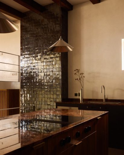 Living-room fireplace clad in zellige tiles