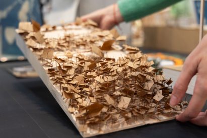 Student holding an architecture project