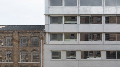 Steel extension on top of grey brick warehouse