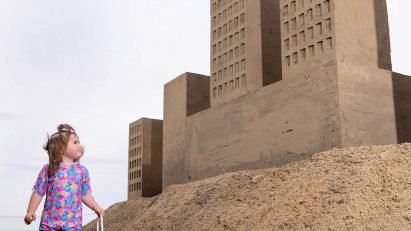 Girl looking at sand castles