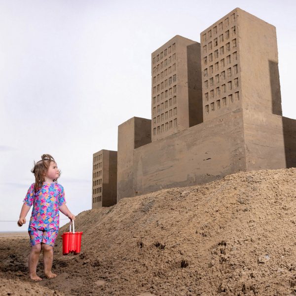Girl looking at sand castles