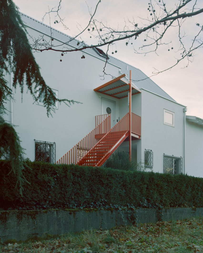 Red steel staircase leading to upper level apartment