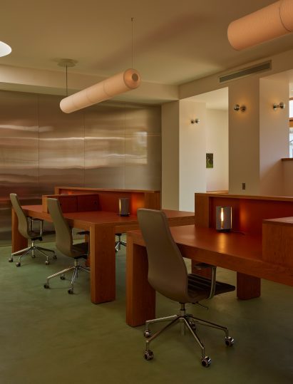 Central workstations sat on green carpet and against stainless steel panels