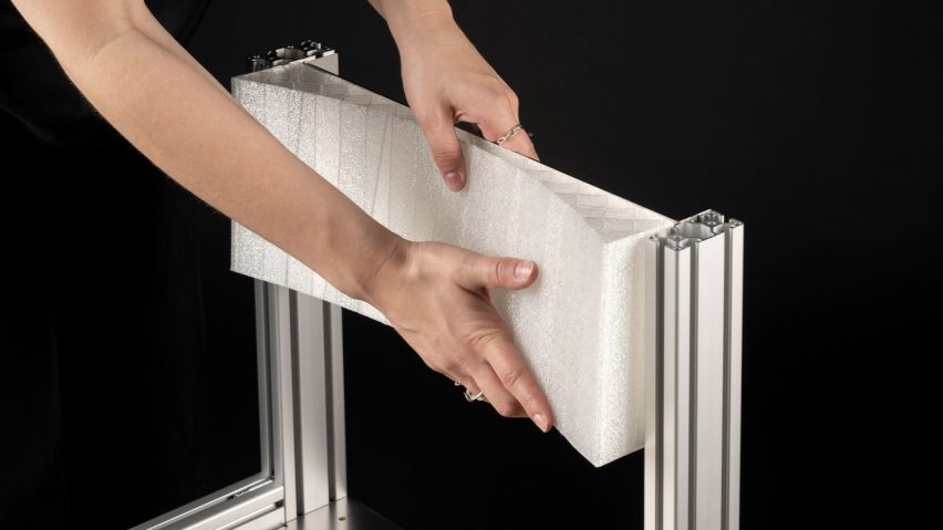 a photograph of a person's hands on a chair in tones of white and silver