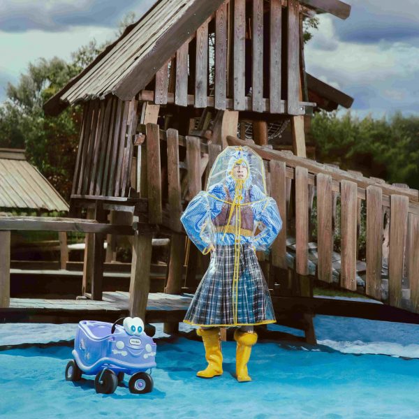 a photograph of a person modelling garments in tones of blue and yellow