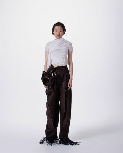 a photograph of a person wearing garments in tones of black and white