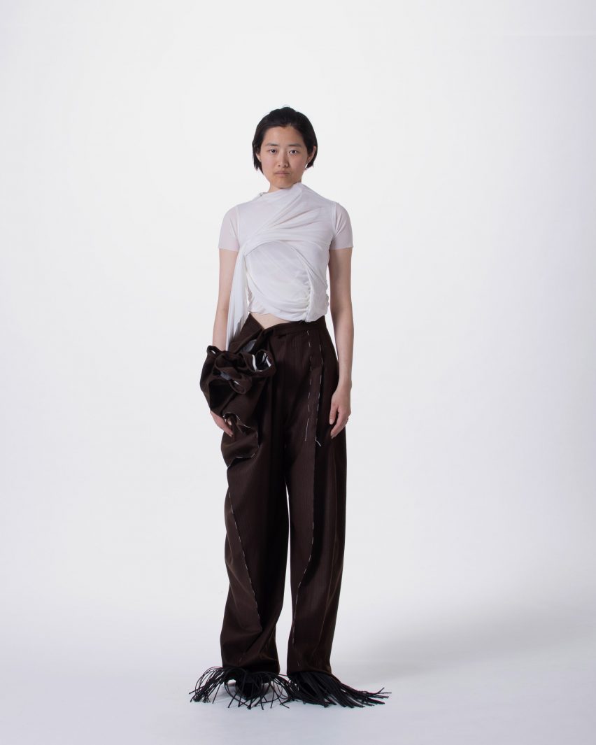 a photograph of a person wearing garments in tones of black and white