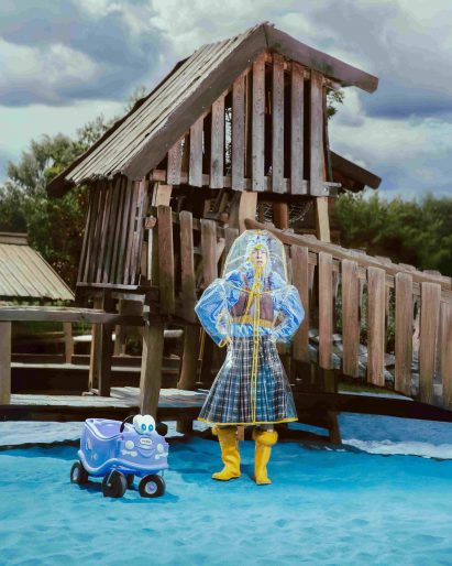 a photograph of a person modelling garments in tones of blue and yellow