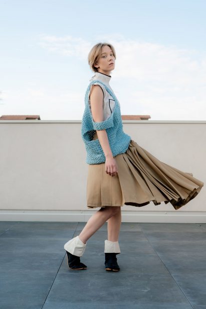a photograph of a person in blue and beige clothing