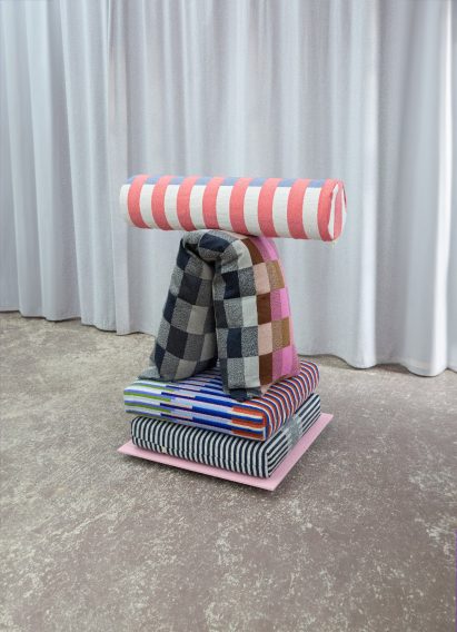 a photograph of cushions in tones of blue, grey, pink and white