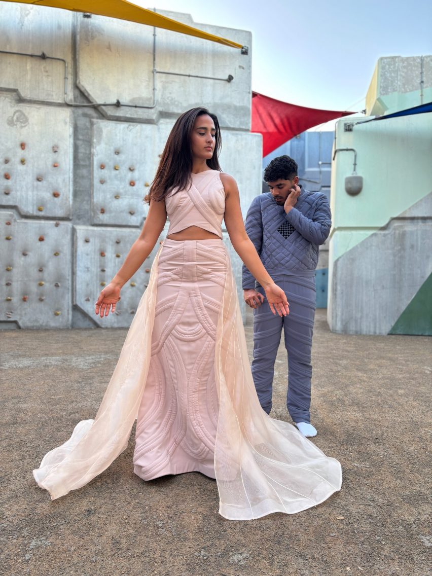 one person in a pink dress and another in blue garments