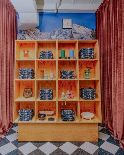 Objects and merch stored in wooden display unit