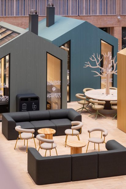 University interior with house-shaped meeting rooms and seating areas
