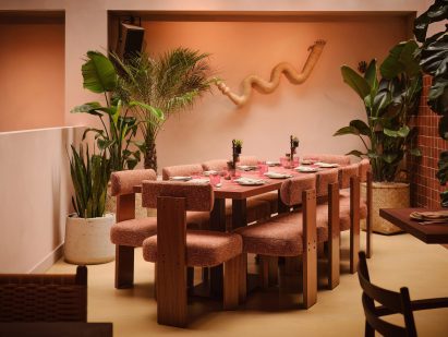 table and chairs with woven sculpture on wall