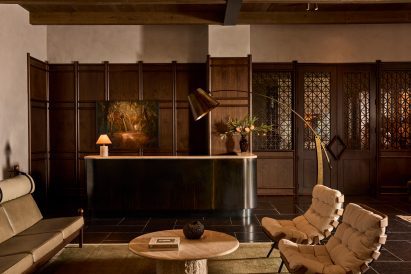 Dark wood panelling installed against textured plaster across a hotel lobby's walls
