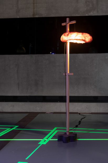 a photograph of a pole with an illuminated object attached to it