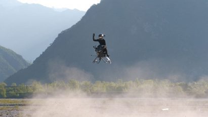 Person waving from flying hovercraft 