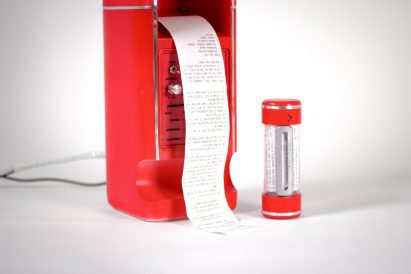 Receipt coming our of red machine