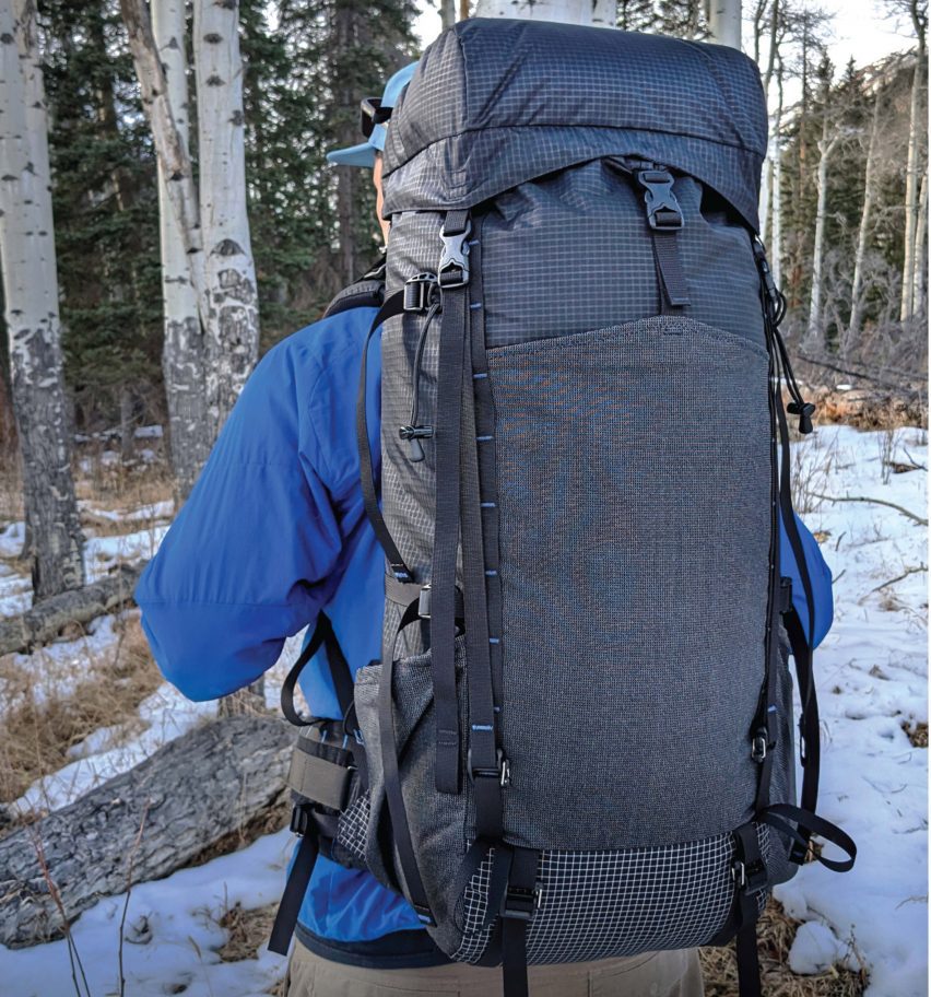a photograph of a person holding a backpack