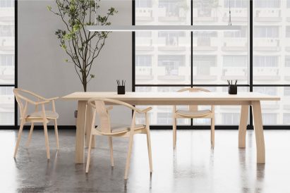 Three wooden chairs clustered around a wooden table