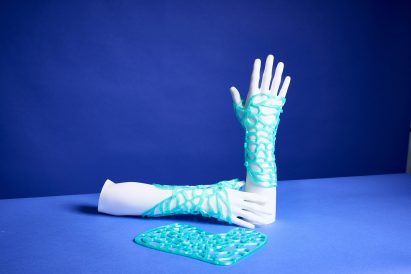 a photograph of models of hands with blue netting on