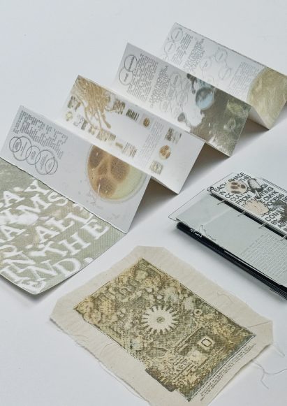 a photograph of printed leaflets in tones of white and beige