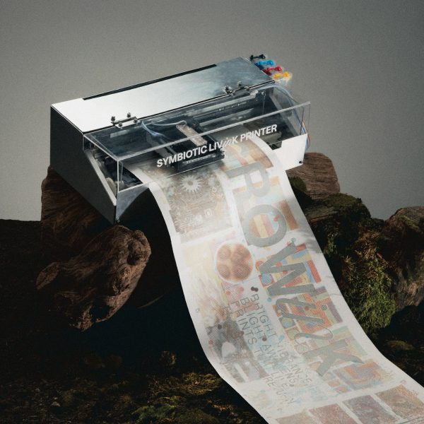 a photograph of a printer printing a sheet of white paper with brown and beige images and text on it
