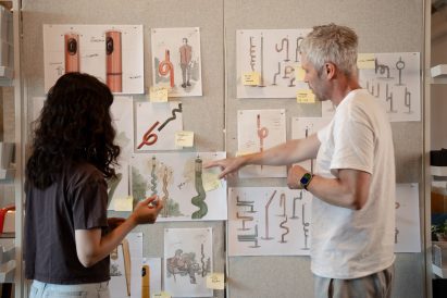 People pointing at drawings